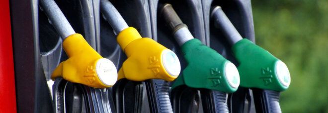 A row of yellow and green gas nozzles.