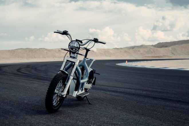 An electric moped parked on the road.