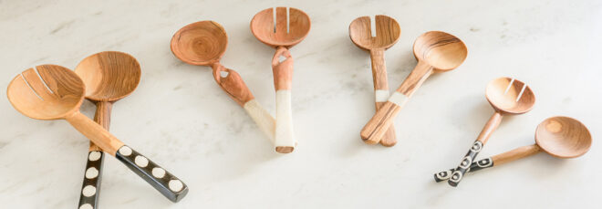 A half-circle display of five sets of wood spoons.