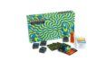 A patterned blue and green game box with cards and game pieces set out in front of it.