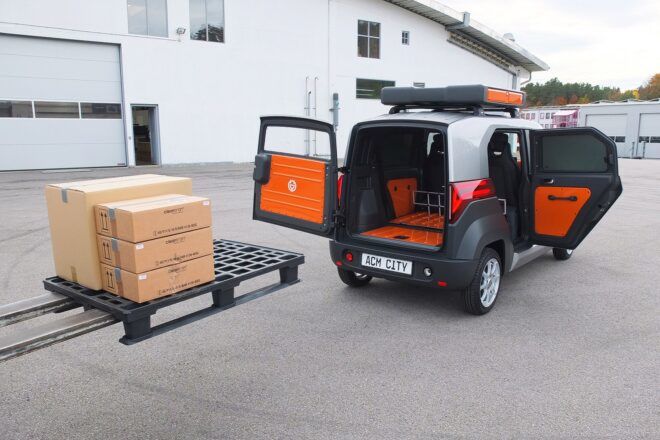 The back doors of a car opening up to load packages.