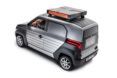 The back of a black and silver car with roof rack.