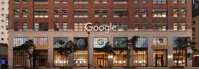 A streetview of a store on the ground level of a brick building, with a white "Google" sign and a colorful "G" symbol underneath it.