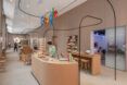 A front desk/checkout counter with the classic Google logo hanging above it as a sign.