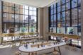 A minimalist retail space surrounded by glass walls with black frames.