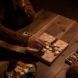 An overhead view of a person playing a wooden board game.