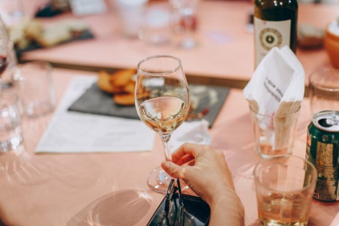 A hand holding a champagne glass