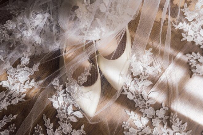 white shoes covered by a wedding veil