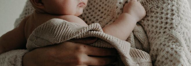 A person holding a baby.