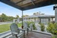 A porch with two deck chairs.