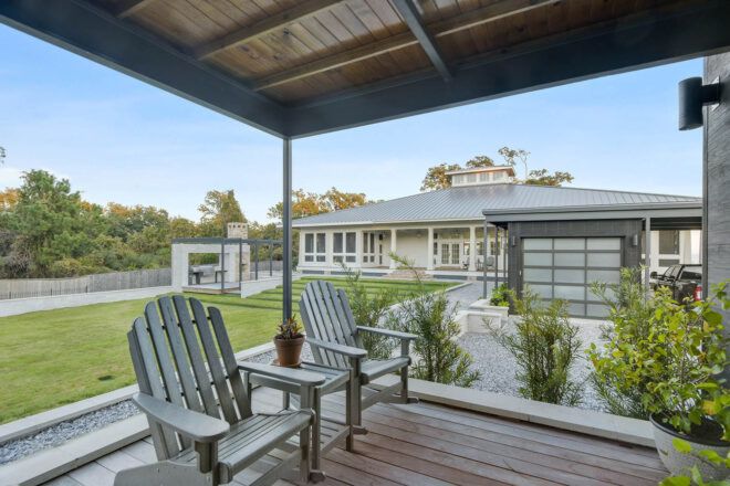 A porch with two deck chairs.