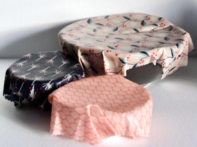 Three bowls of various sizes covered in patterned beeswax wraps