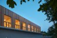 Evening view of wood box resting on concrete building base