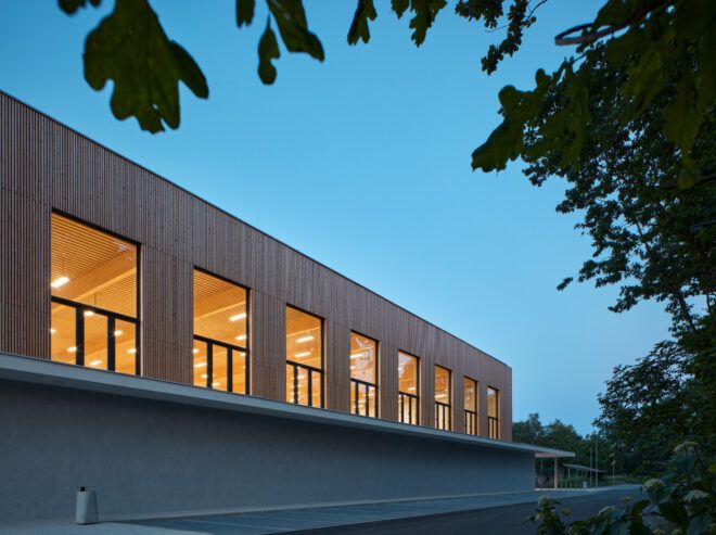 Evening view of wood box resting on concrete building base