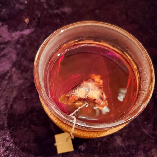 Tea bag seeping in a glass cup