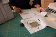 Sketches of bag being designed on a cluttered work table