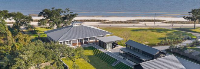 An aerial view of a beach home by the coast.