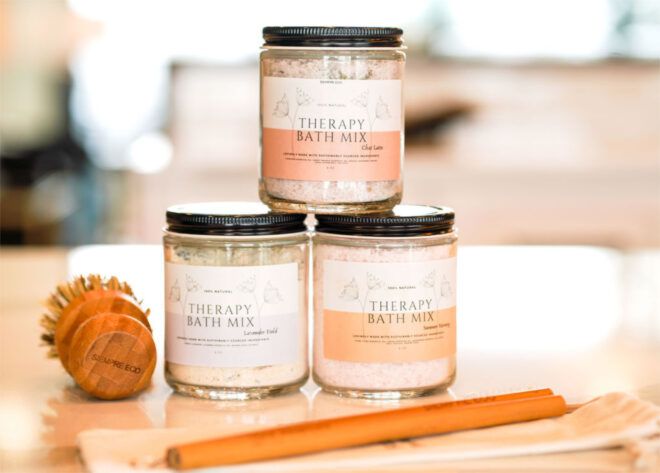 Collection of stacked bath therapy mixes, a bamboo scrubber brush and bamboo straws