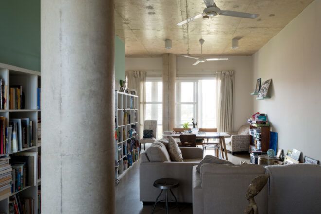 Open plan living and dining room with bookshelves to the left