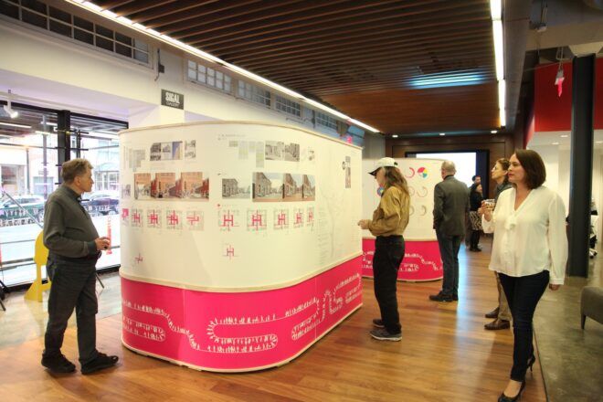 People examining an exhibit indoors.