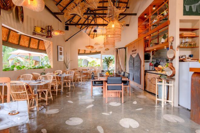 Interior restaurant area with accents of bamboo designs in the chairs, tables and ceiling decor