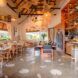 Interior restaurant area with accents of bamboo designs in the chairs, tables and ceiling decor