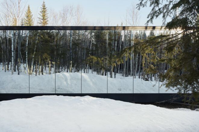Building with a mirror-like glass that reflects the snow it sits on
