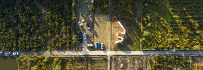 An aerial view of the pavilion in a field.