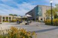 University campus with tables and umbrellas in the foreground