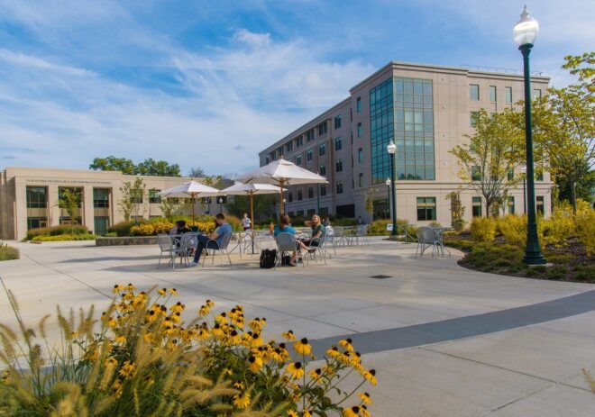 University campus with tables and umbrellas in the foreground