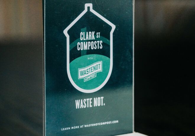 A green Clark Street Composts sign.