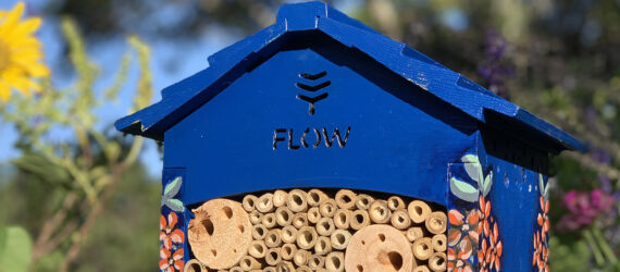 A close-up of a blue Flow Pollinator House.