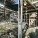 To the left, a green courtyard. To the right, a parking area next to a home.
