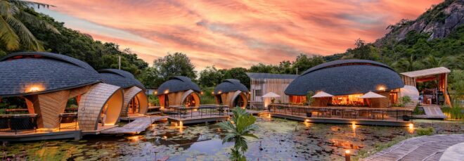 Exterior of turtle-shaped structures against an evening sky