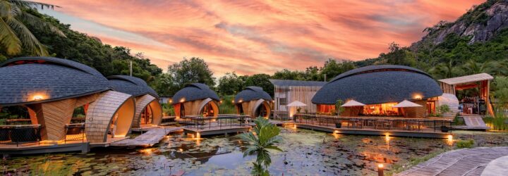 Exterior of turtle-shaped structures against an evening sky