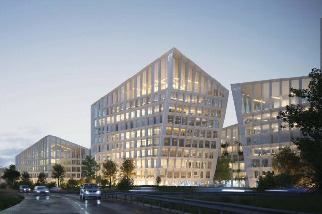 A streetview of three large white buildings with windows lit up from within.