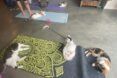 Three cats lounging on a yoga mat