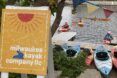 A stream with kayakers, with a sign 