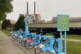 Blue bicycles lined up in a row
