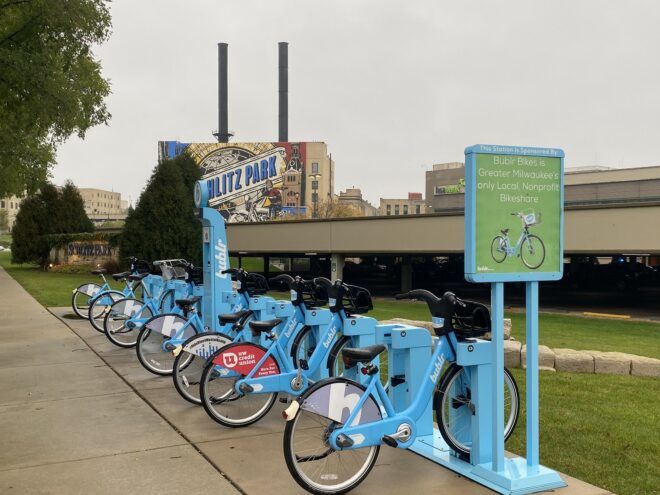 Blue bicycles lined up in a row