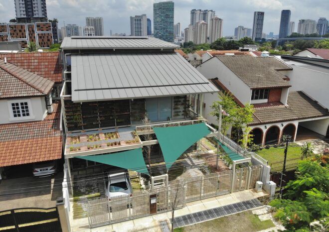 An aerial view a house with a semi-covered parking area.