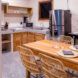A kitchen/dining area with white walls and wood cabinets and furniture.
