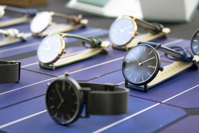 Several watches on a blue mat.