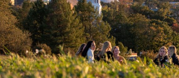 Students talking to each other in the grass