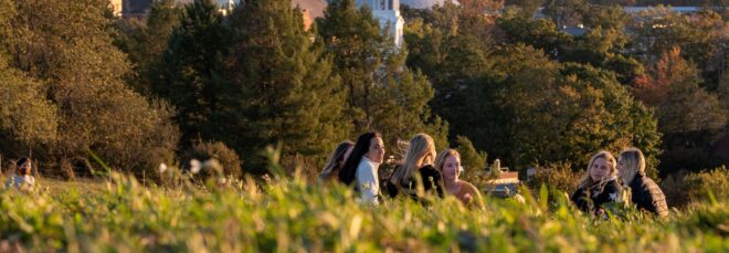 Students talking to each other in the grass
