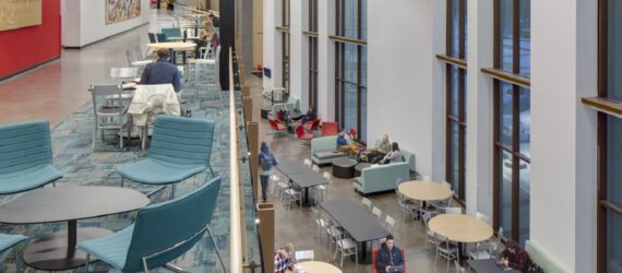 Interior of university with two floors of tables and chairs for students to sit in