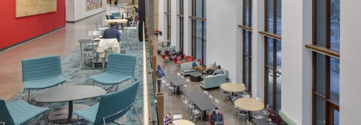 Interior of university with two floors of tables and chairs for students to sit in