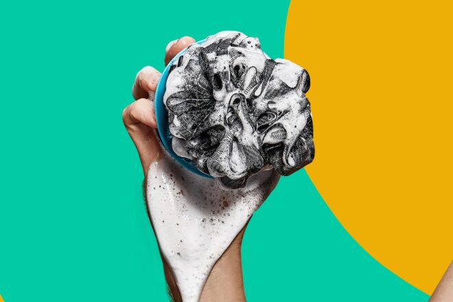 A sudsy loofa-looking product held by a hand