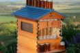 A Flow Pollinator House covered in jars of honey.