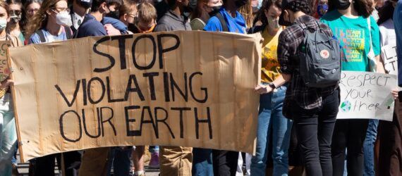 A line of protests holding a sign that says 